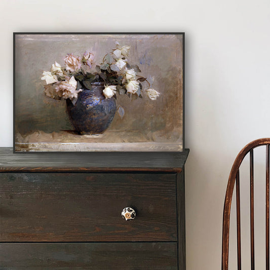 A wooden chair in front of a dark wooden dresser with a framed print of roses in a vase resting on top.
