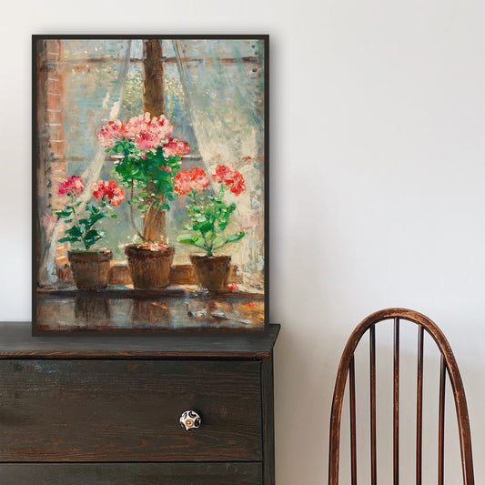 Framed print of potted plants, resting on a wooden dresser with a chair in the corner.