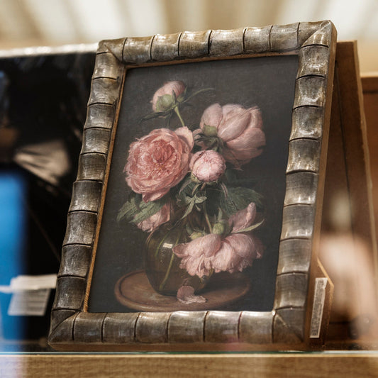 Decorative frame with a fine art print of pink peonies on a dark background