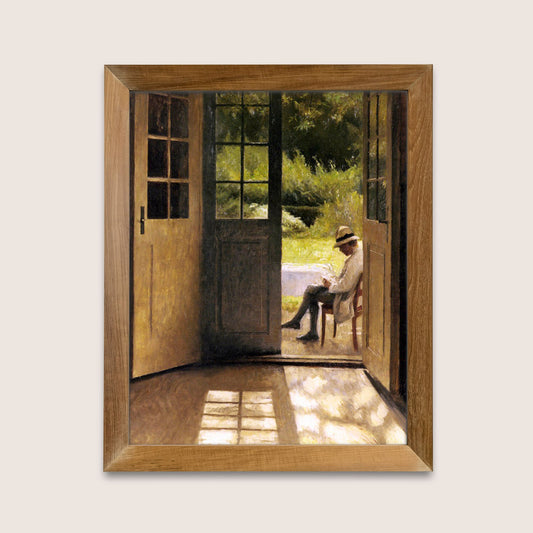 Framed artwork of a man sitting in a chair by an open door leading to a garden.