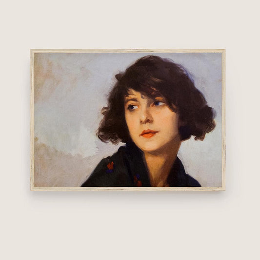 A fine art print of a portrait in oil of a young lady from the Art Deco period. The print is displayed in a thin wooden picture frame.
