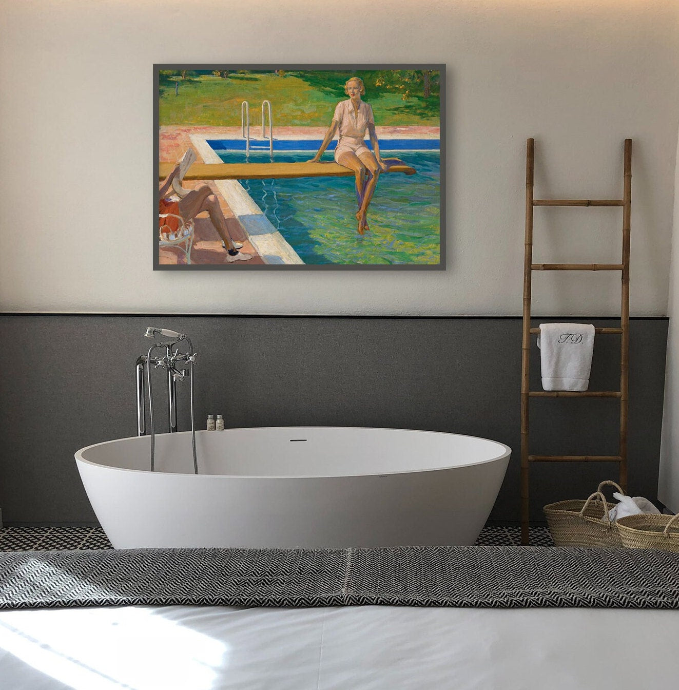 A fine art print of a beautiful Art Deco portrait in oil of a young lady resting on a spring board above a swimming pool. The print is displayed hanging on the wall above a bath in a luxury bathroom in a thin dark picture frame.