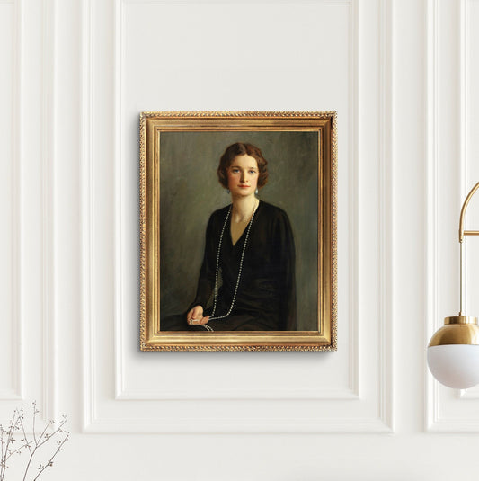 Framed portrait of a woman, hung on a white wall, in a gold ornate frame.
