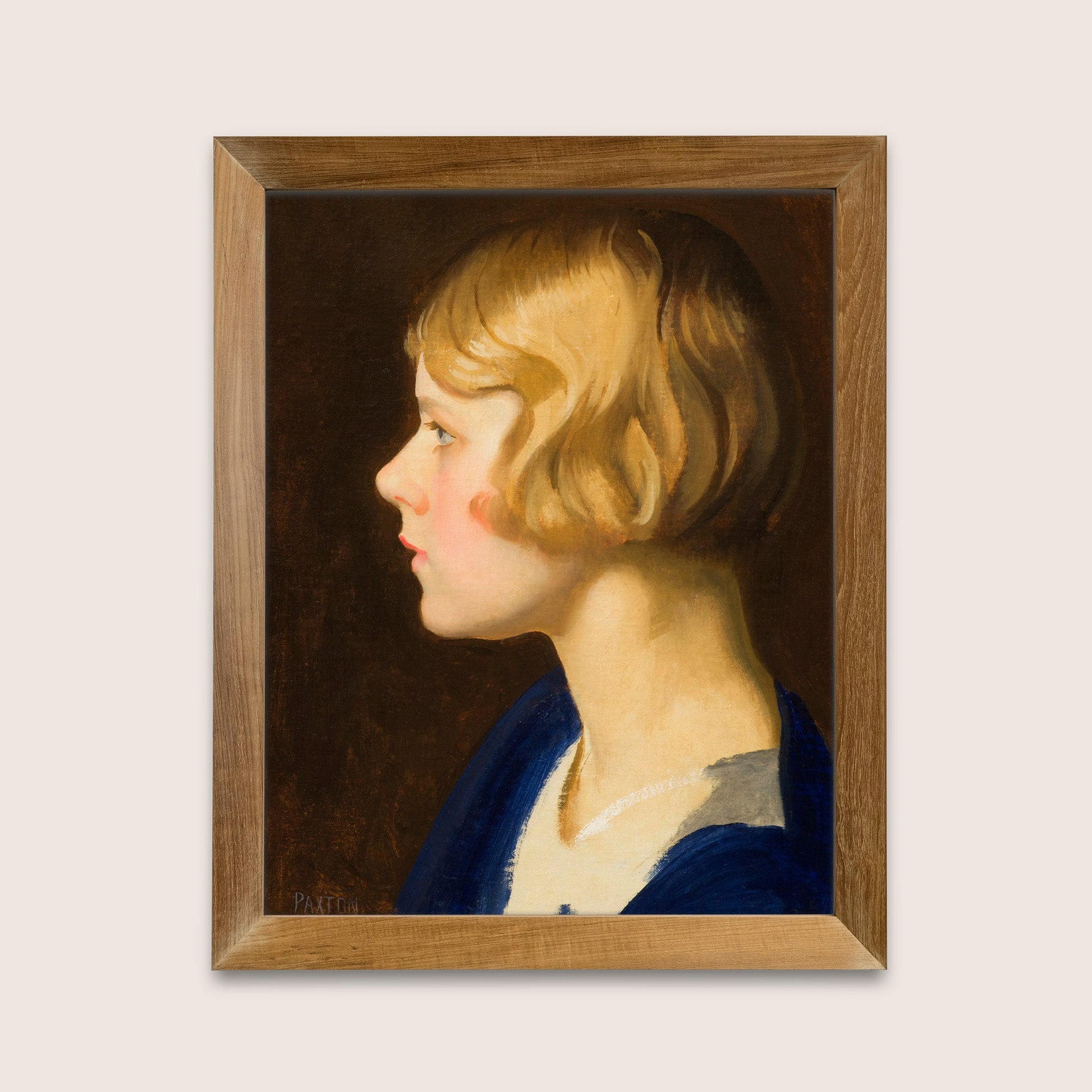 Framed portrait of a young girl with blonde hair, hung on a plain background
