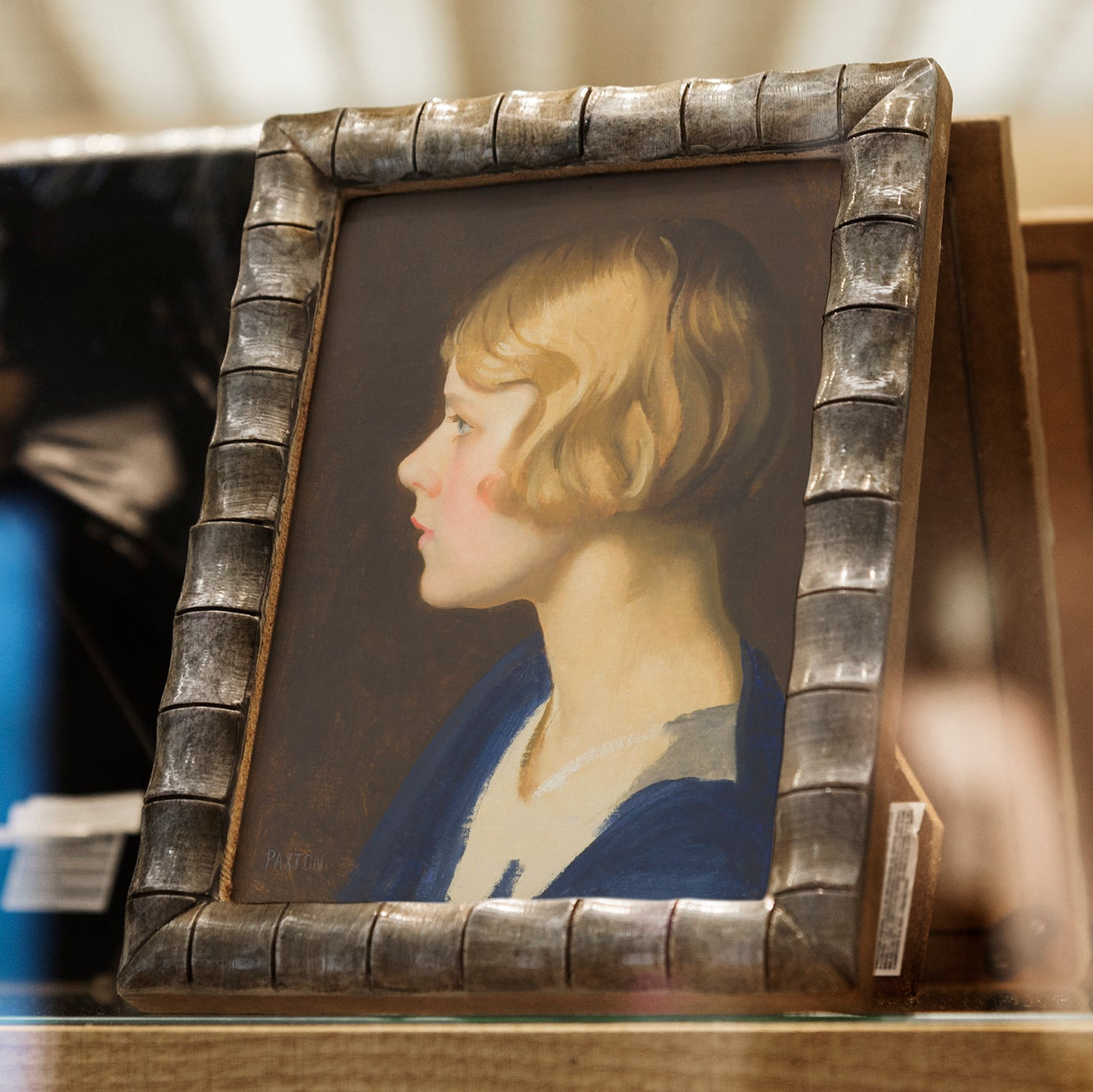 Small portrait of a woman in a decorative frame on a table