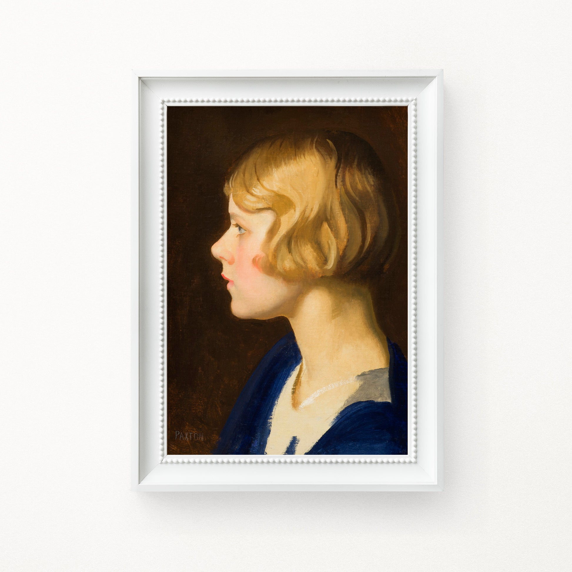 Framed portrait of a young girl with blonde hair and a blue dress, hung on a white background