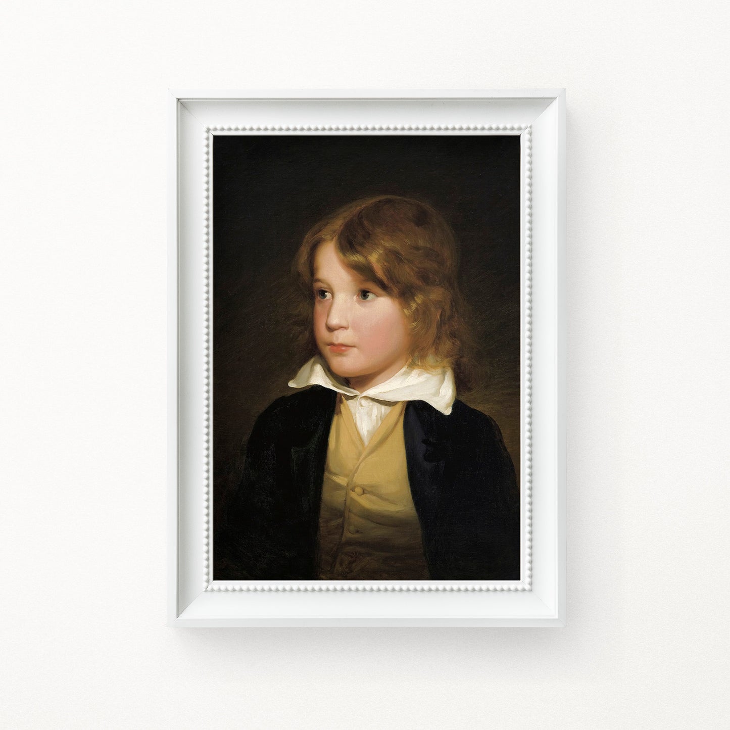 Framed portrait of a young boy with a white frame on a white background