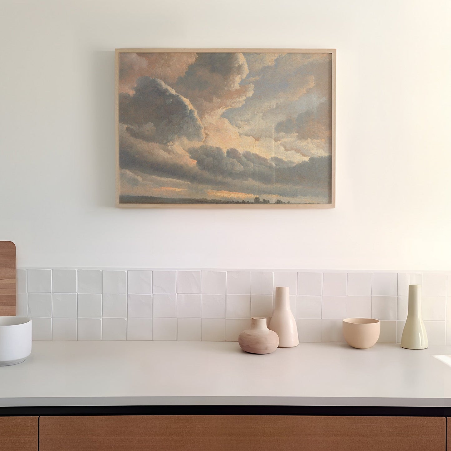 Modern kitchen with a painting of clouds above a countertop with decorative vases.