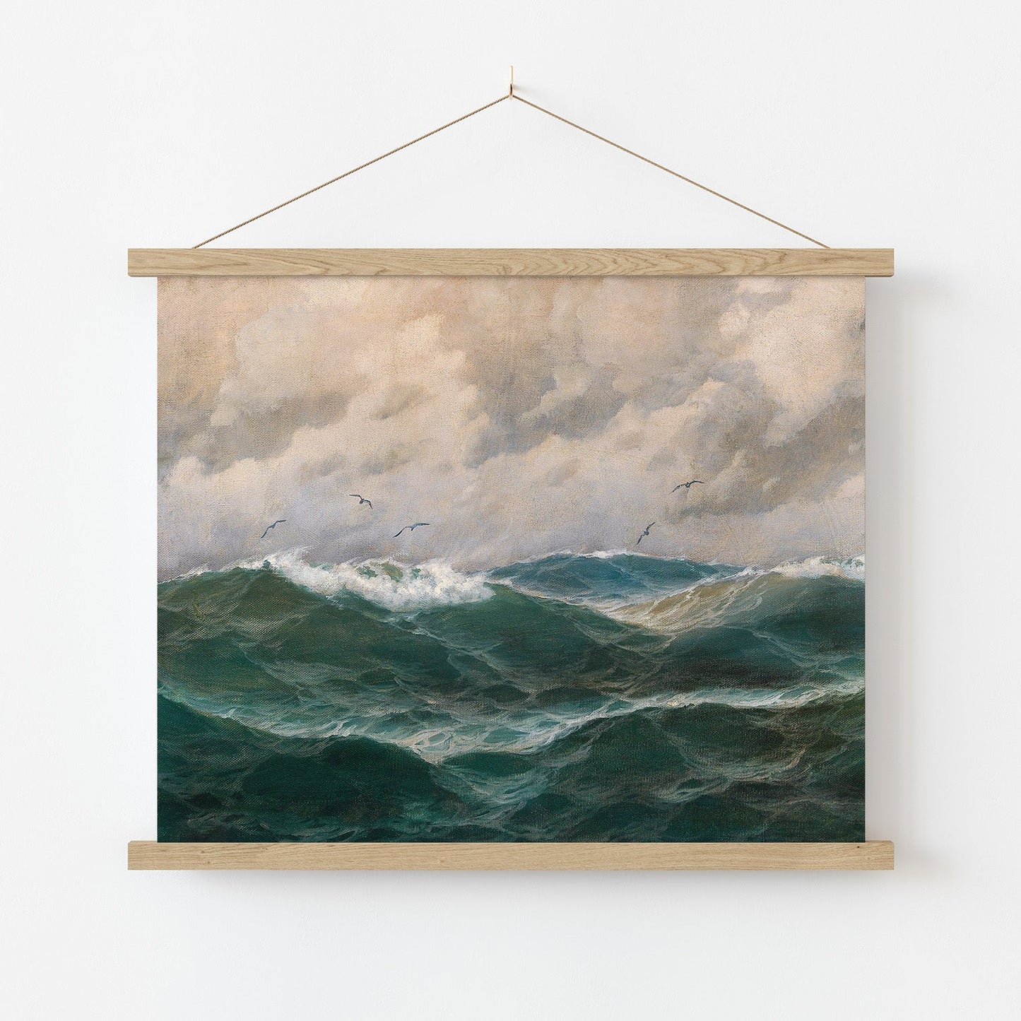 Framed artwork of a seascape with turbulent ocean waves and cloudy sky.