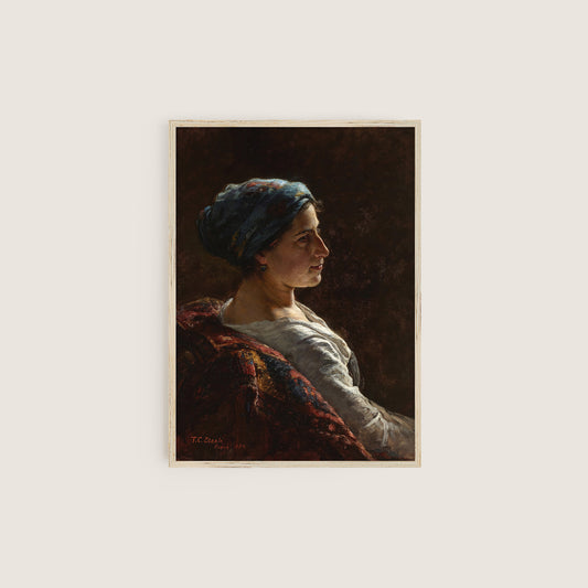 A framed print of a female portrait in a wooden frame on a white wall.