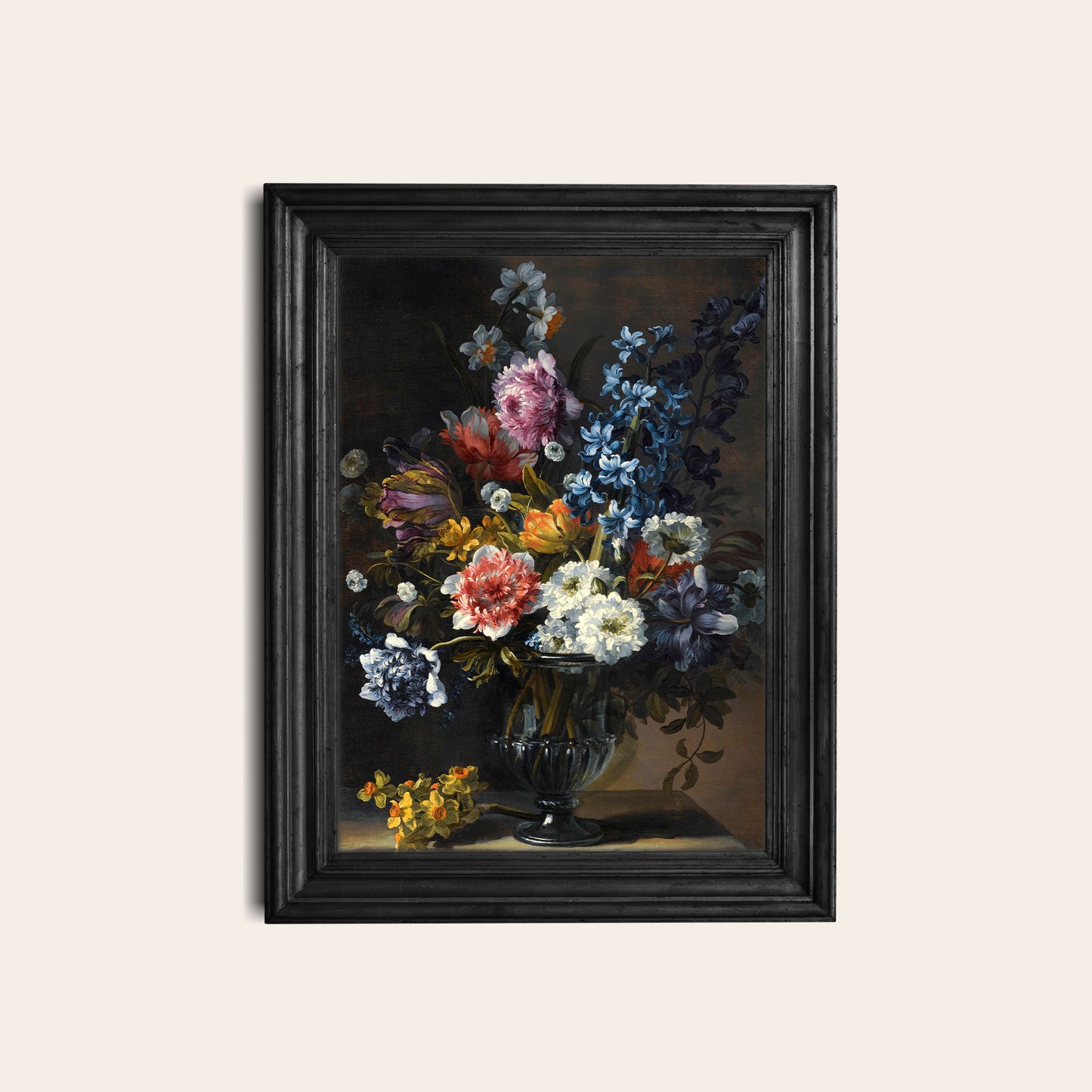 Framed floral print in a black frame on a white wall.