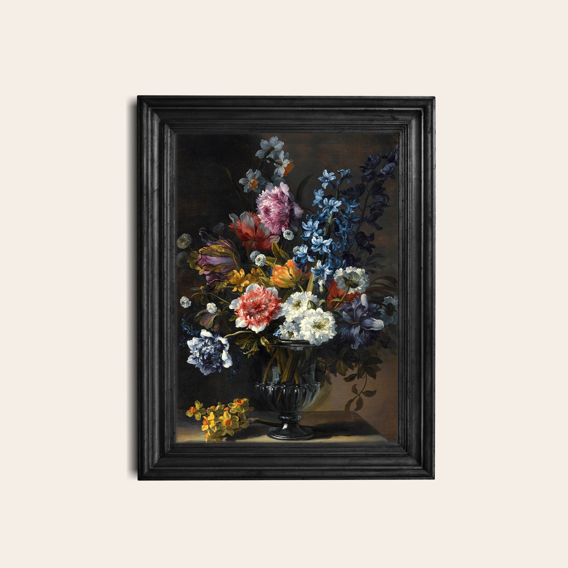 Framed floral print in a black frame on a white wall.
