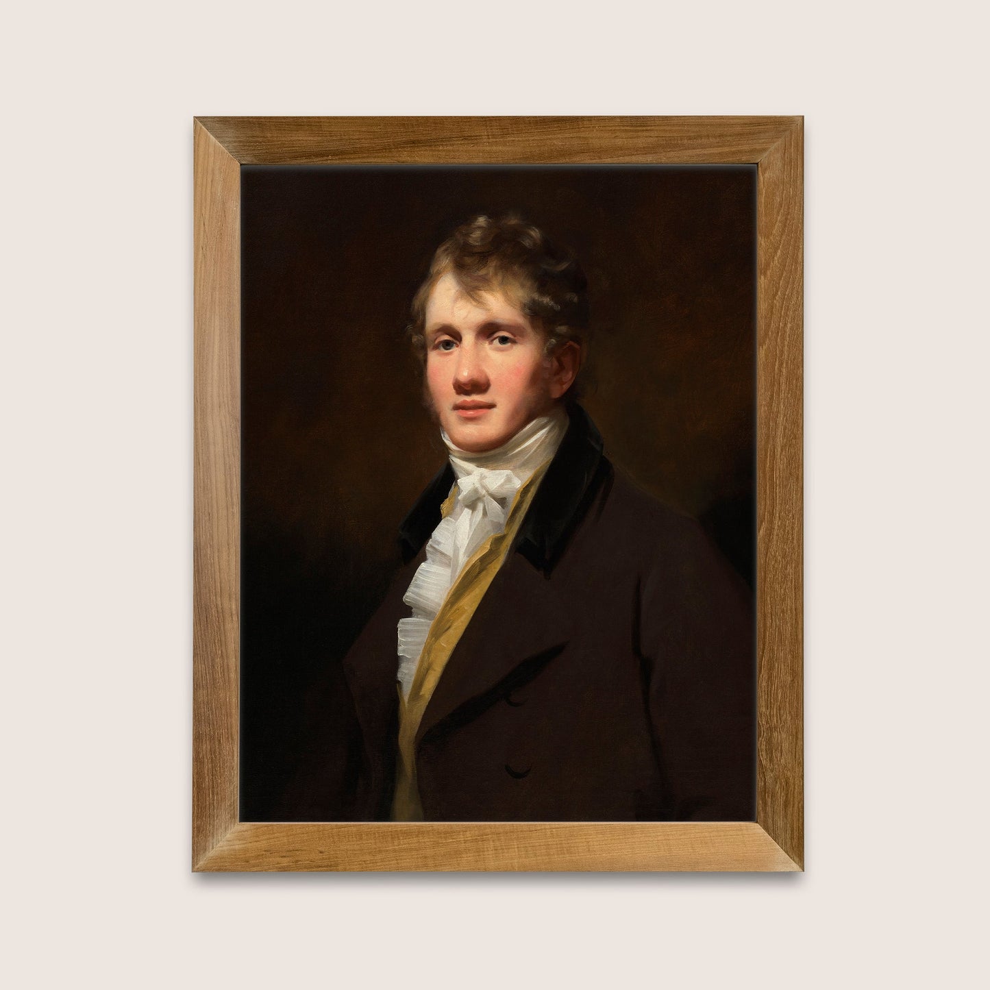 Framed classical portrait print of a man in formal attire in a wooden frame on a white wall.