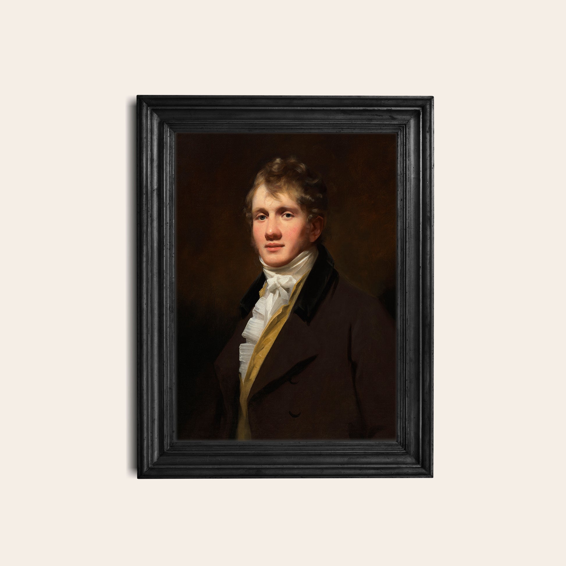 Framed portrait of a man in formal attire in a black frame on a white background