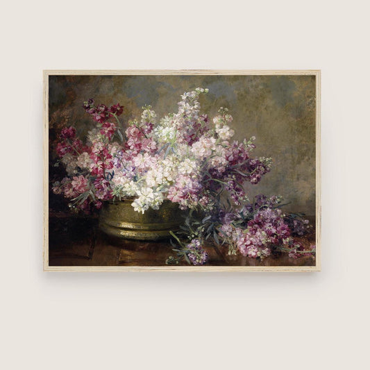 A fine art print of beautiful flowers in pinks and white, displayed in a brass bowl. The print is displayed in a simple wooden picture frame.