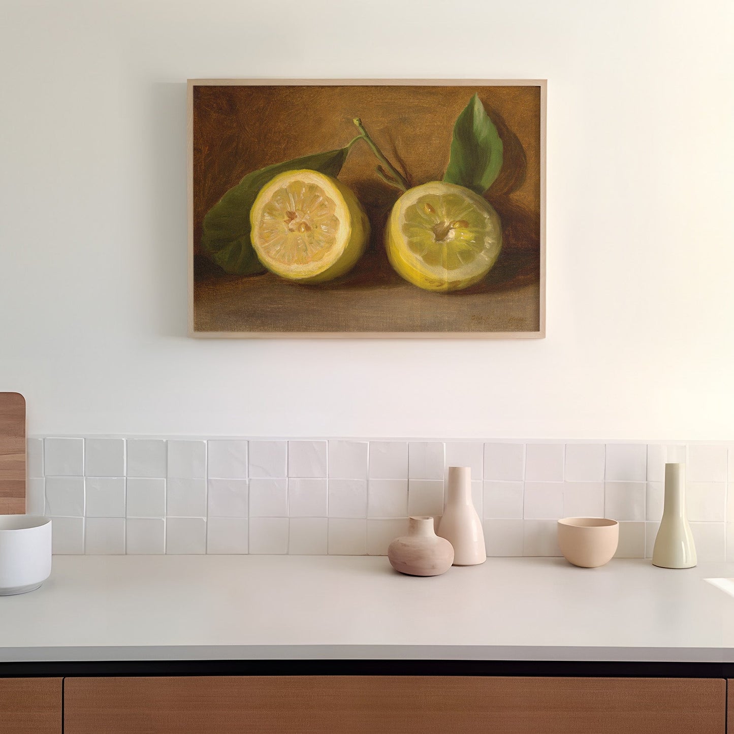 Kitchen counter with decorative items and a print of lemons on the wall in a wooden picture frame.