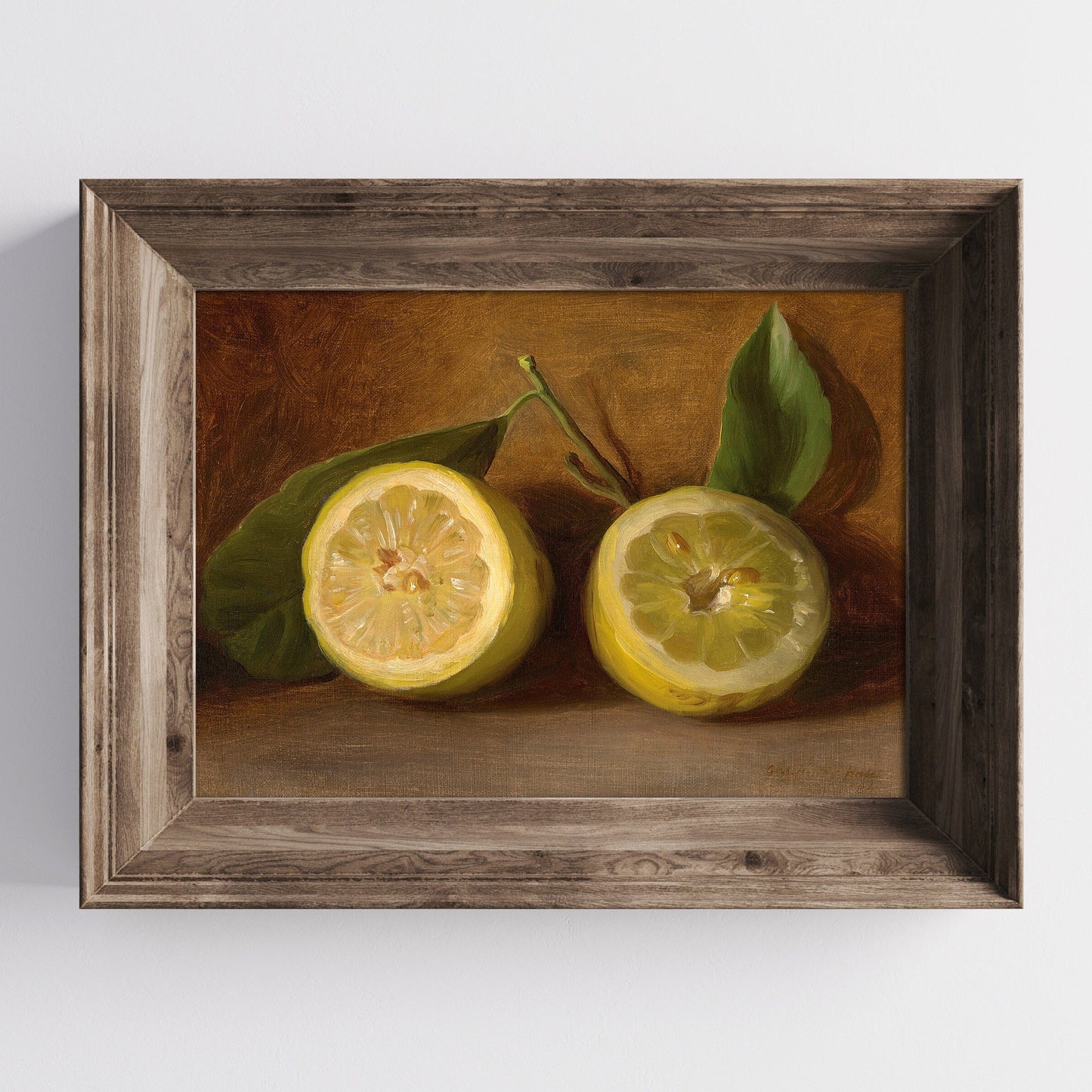 A fine art print of a 19th-century oil still-life painting of a halved lemon. The print is displayed in a wooden picture frame on a white wall.