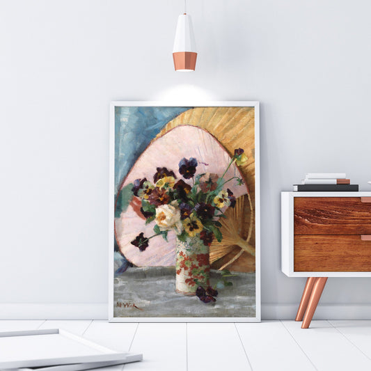 Framed artwork of a floral arrangement leaning against a wall in a modern interior setting.