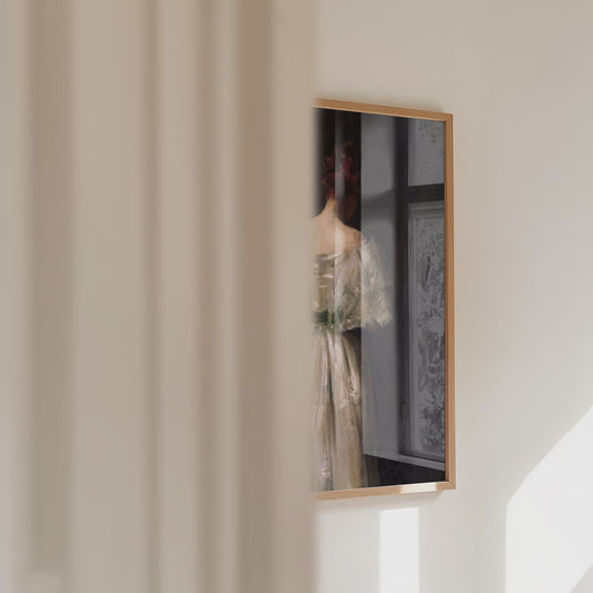Video of a framed female portrait print panning across.