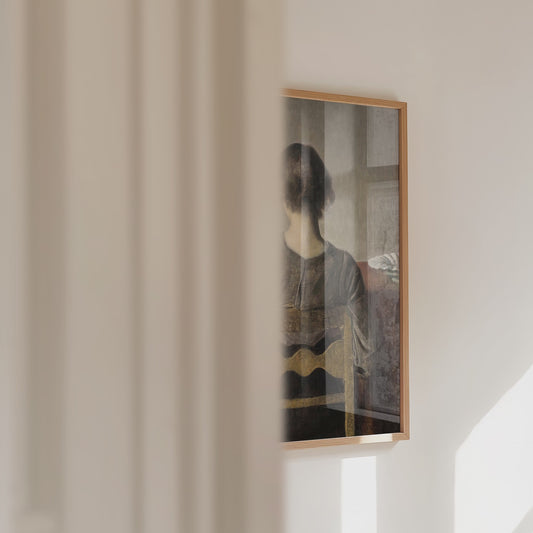Video of a framed portrait of a female resting on a chair