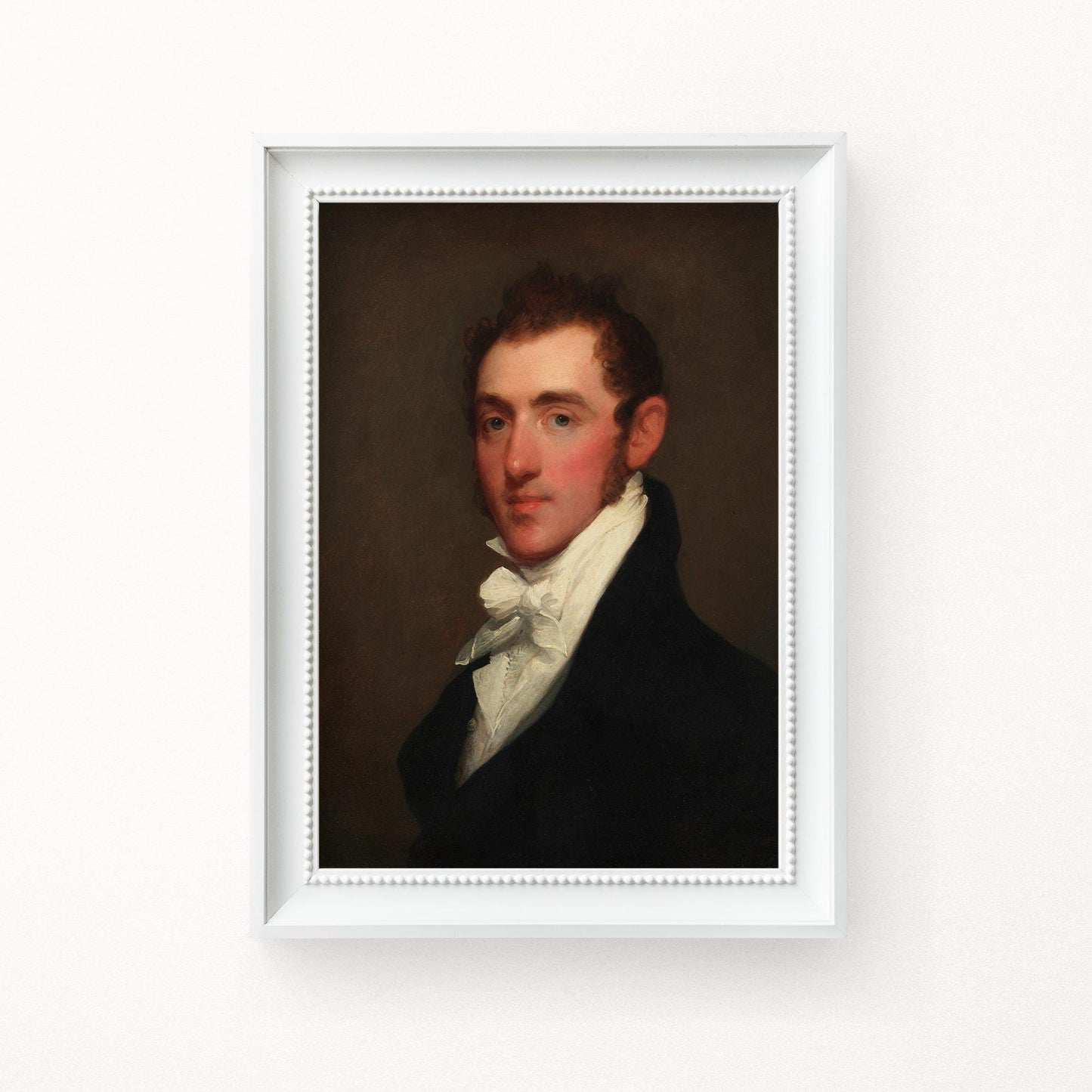 A fine art print of a Regency-era gentleman. The print is displayed hanging on the wall in a white wood picture frame.