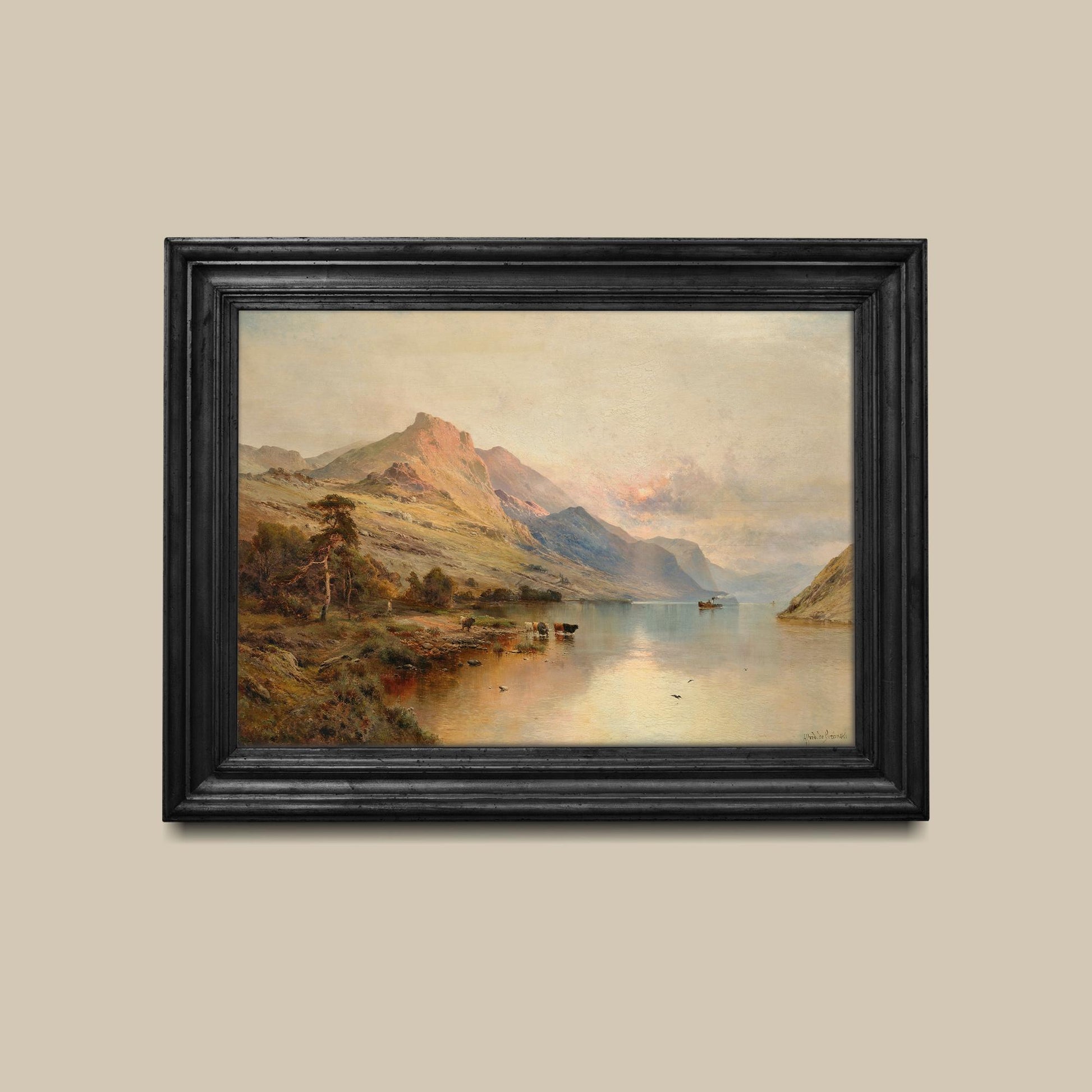 Framed print of a mountain landscape with a lake on a beige wall.