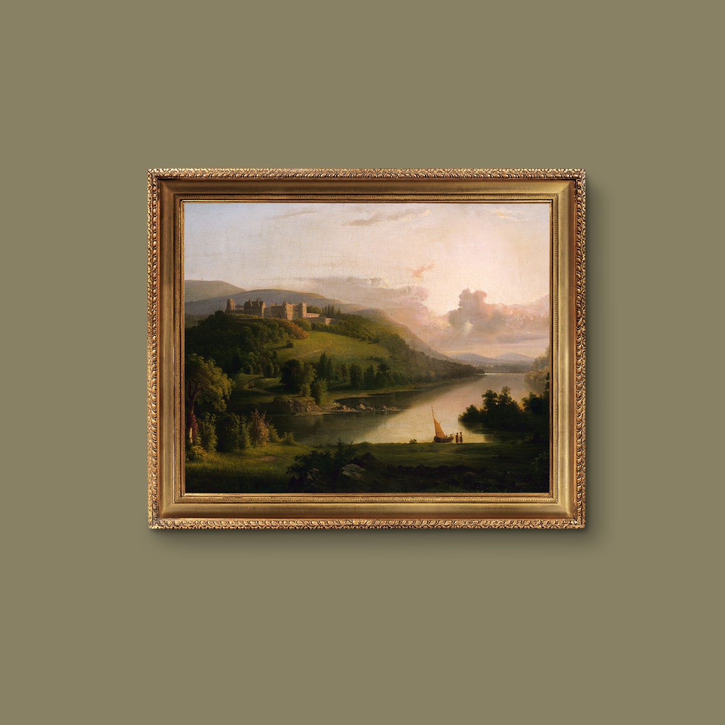 Framed landscape painting of a river scene with hills and a castle on a green wall.