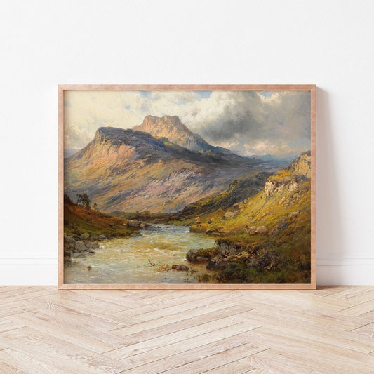Framed print of a Scottish mountain landscape with a river on a white wall.
