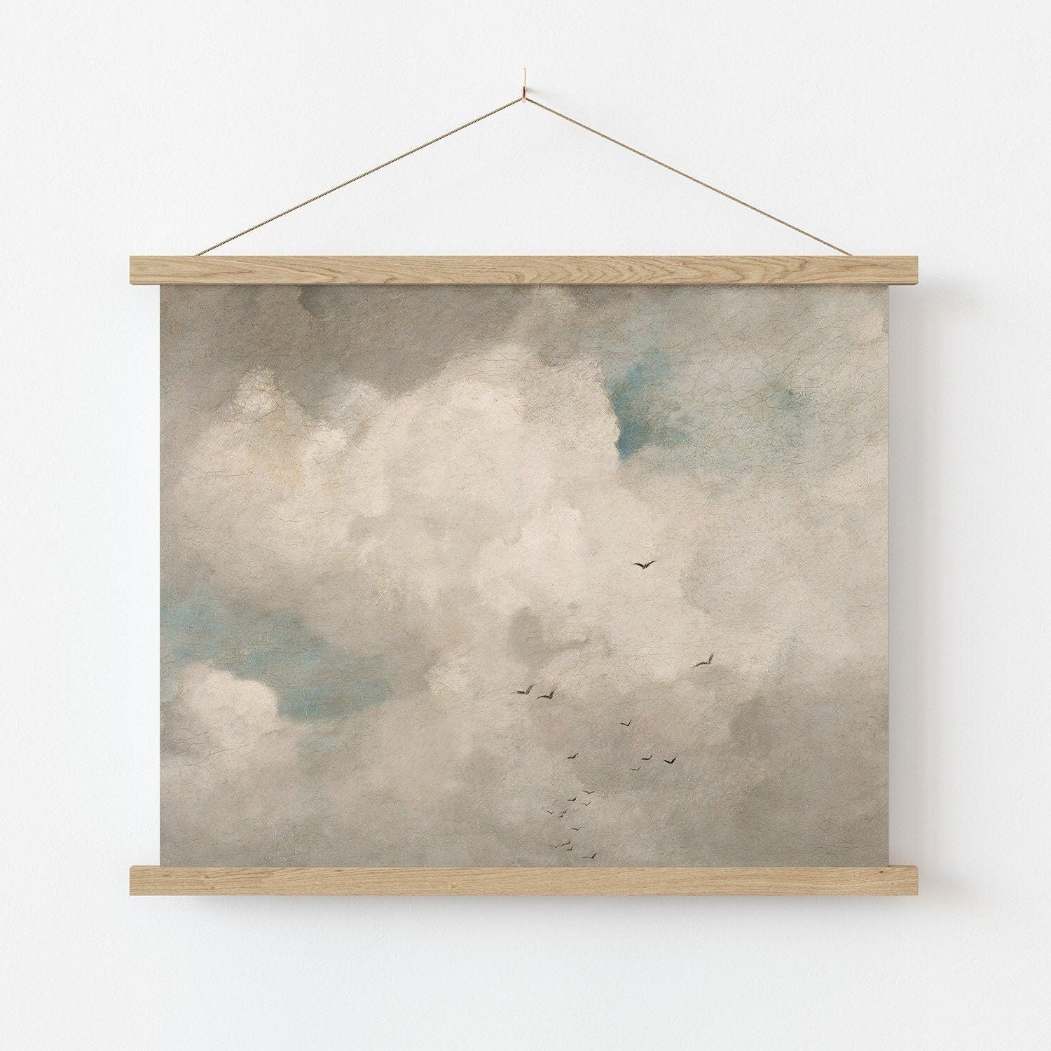 Fine art print of a cloud scene with birds hanging on a white wall
