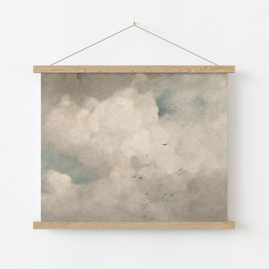 Fine art print of a cloud scene with birds hanging on a white wall